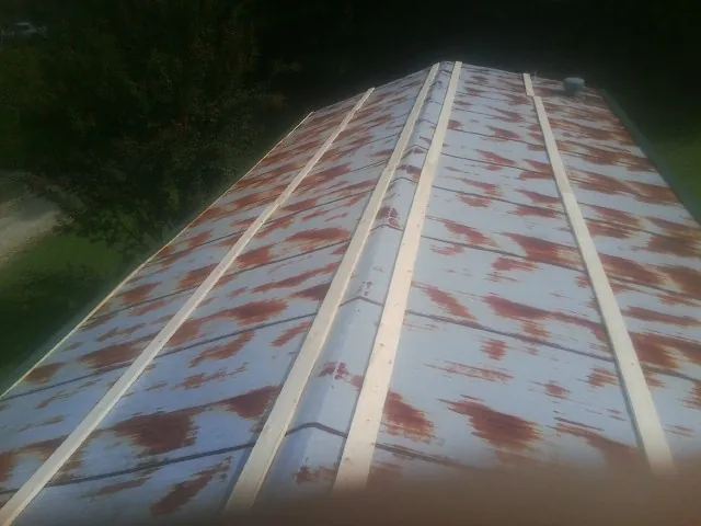 Rusted metal roof panels with new wood purlins before replacement — Storm Damage Roof Repair in Montague by Roofing Brothers