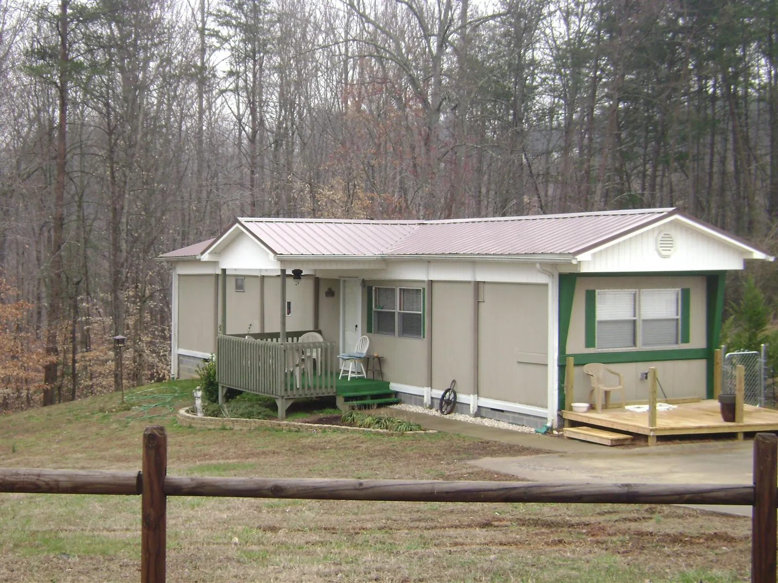 Mauve metal roof on a manufactured home with a new front deck in Montague